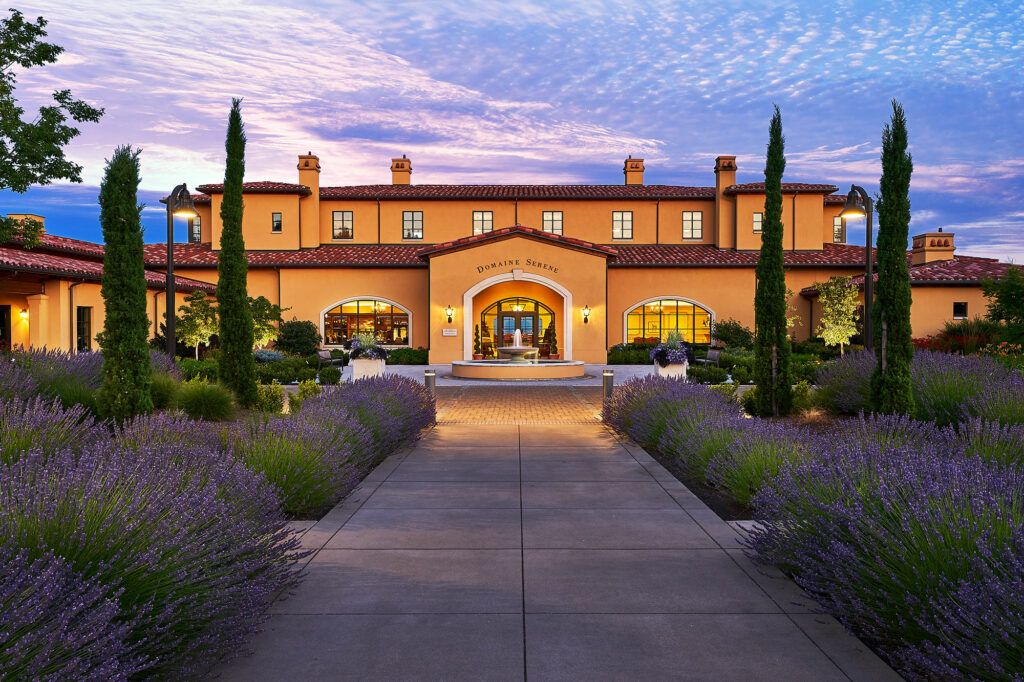 View of the outside of the exclusive Domaine Serene Clubhouse at dusk
