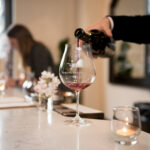 Pouring a glass of Domaine Serene wine for a guest