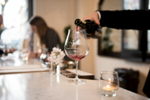 Pouring a glass of Domaine Serene wine for a guest