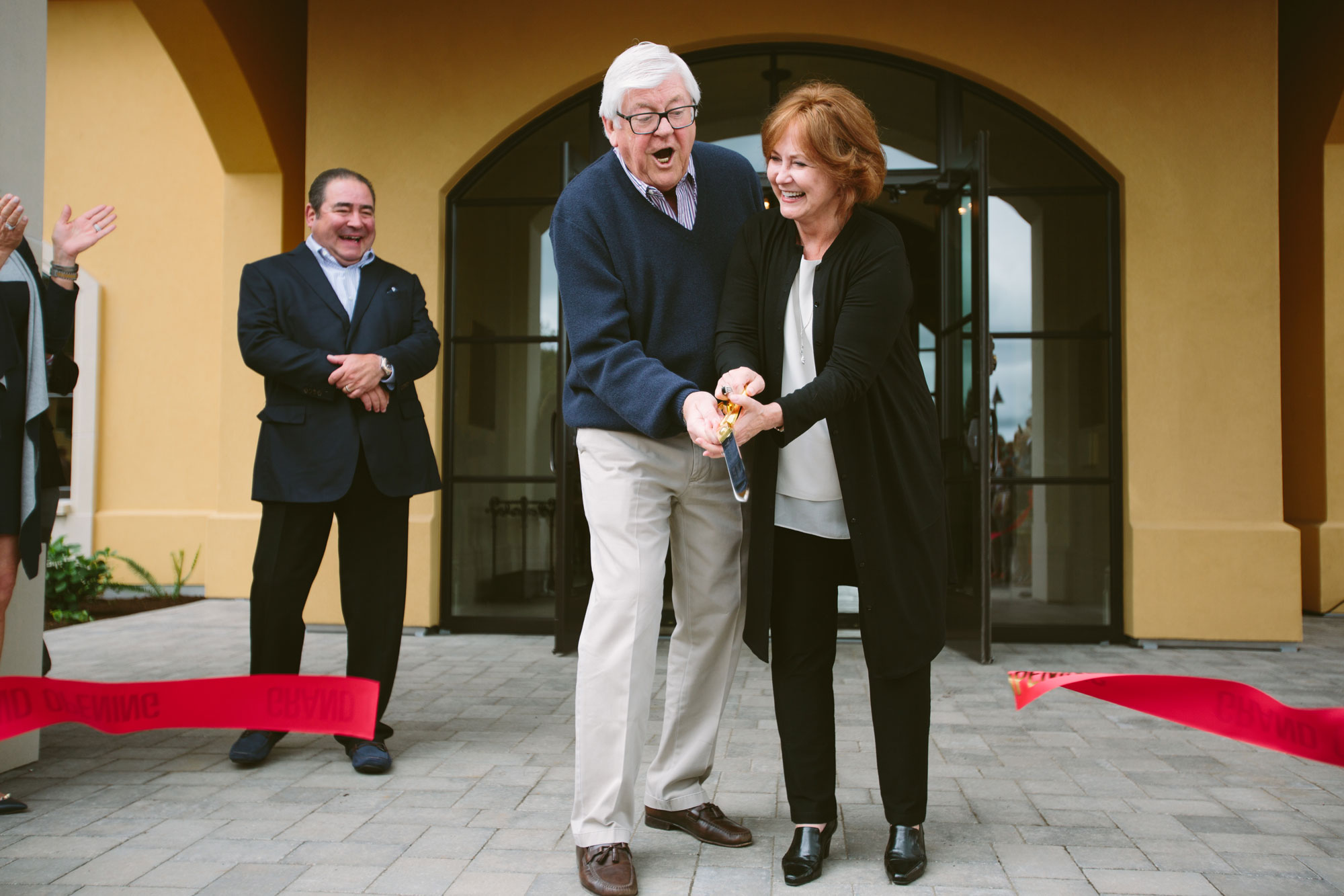Grace and Ken cutting the ribbon at the grand opening of the Domaine Serene Wine Lounge