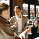 Women laughing and drinking wine at the Domaine Serene Wine Lounge Bend